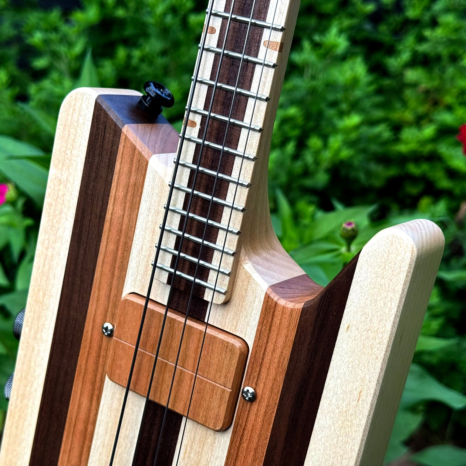 Close-up of a custom solid-body headless ukulele.