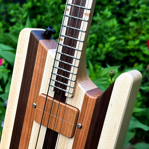 Close-up of a custom solid-body headless ukulele.