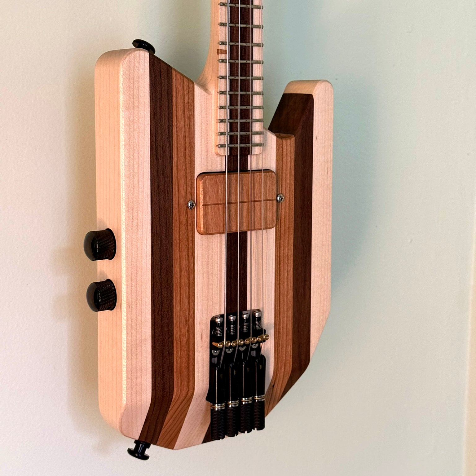 Close-up of the bottom half of a custom solid-body ukulele.