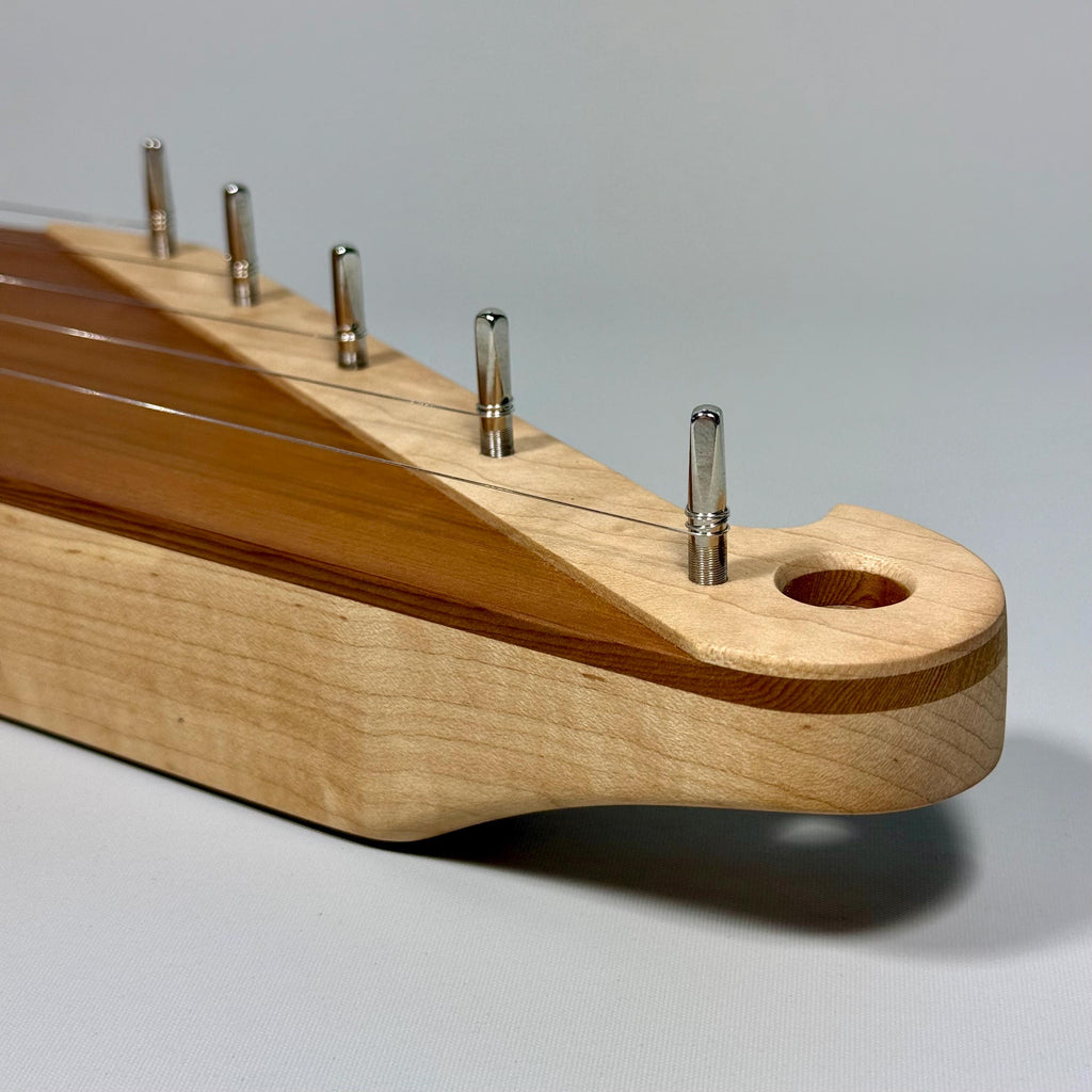 Close-up view of the Kantele head including the tuning pins.