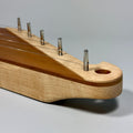 Close-up view of the Kantele head including the tuning pins.