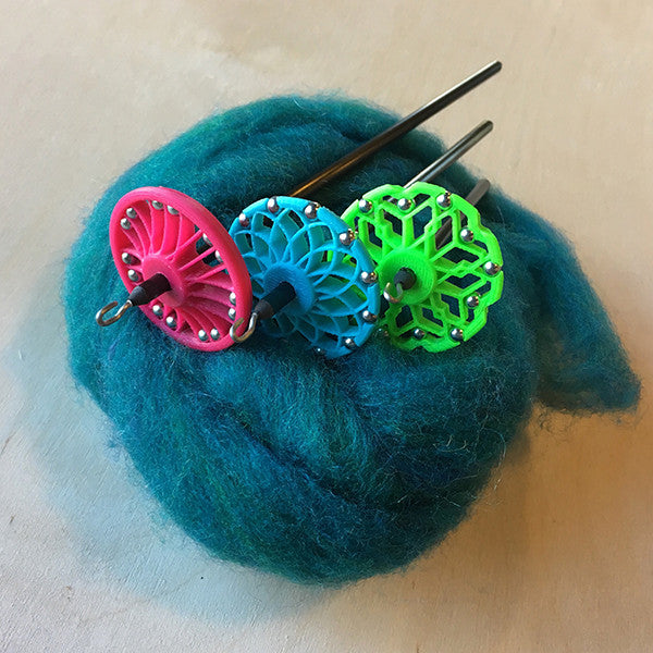 assorted Mini-Spindle Kits: Bike Tire in Magenta, Lotus in Powder Blue, and Honeycomb in Neon Green